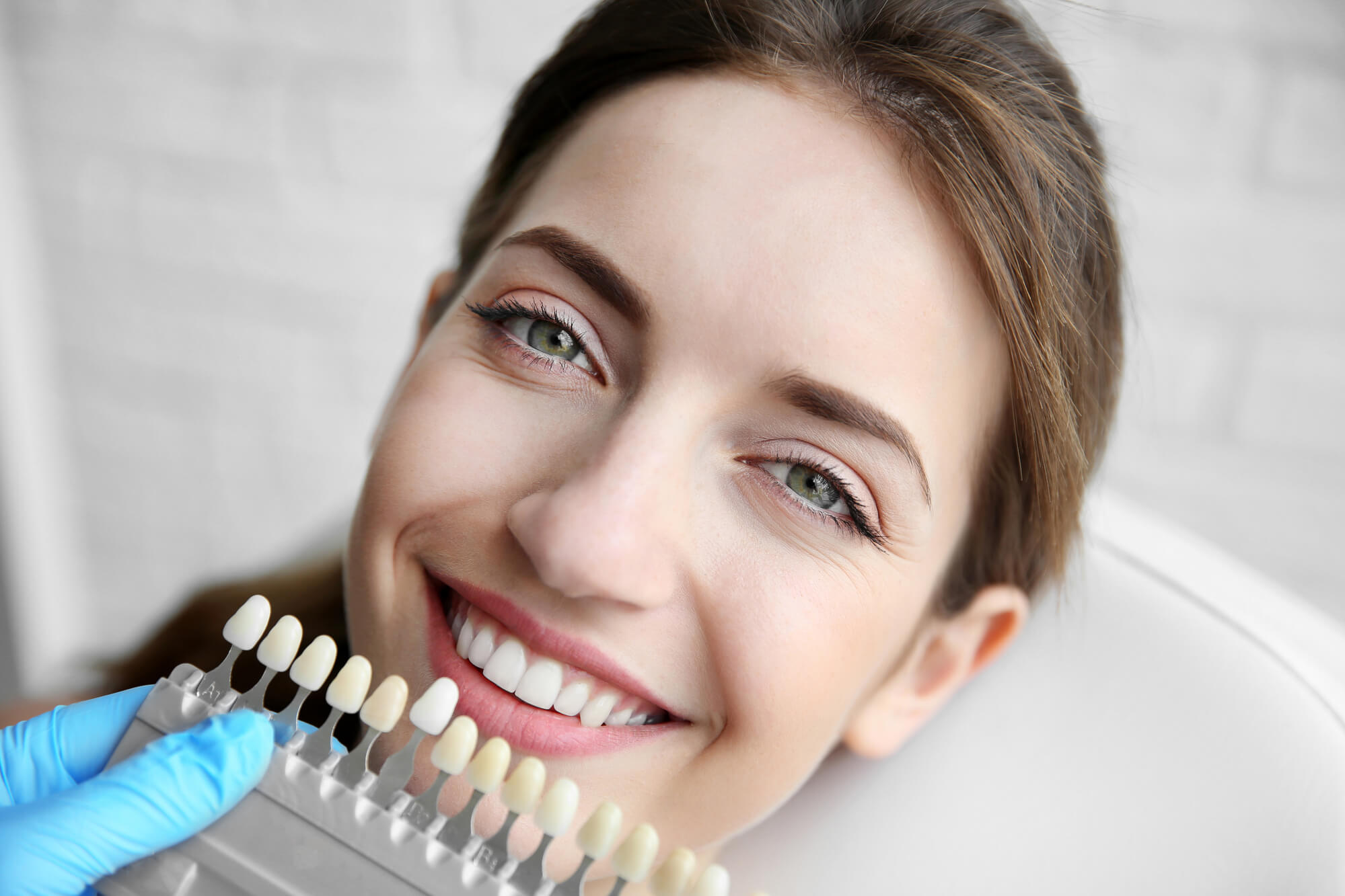 Cosmetic Dentist Miami lets woman choose a veneer color