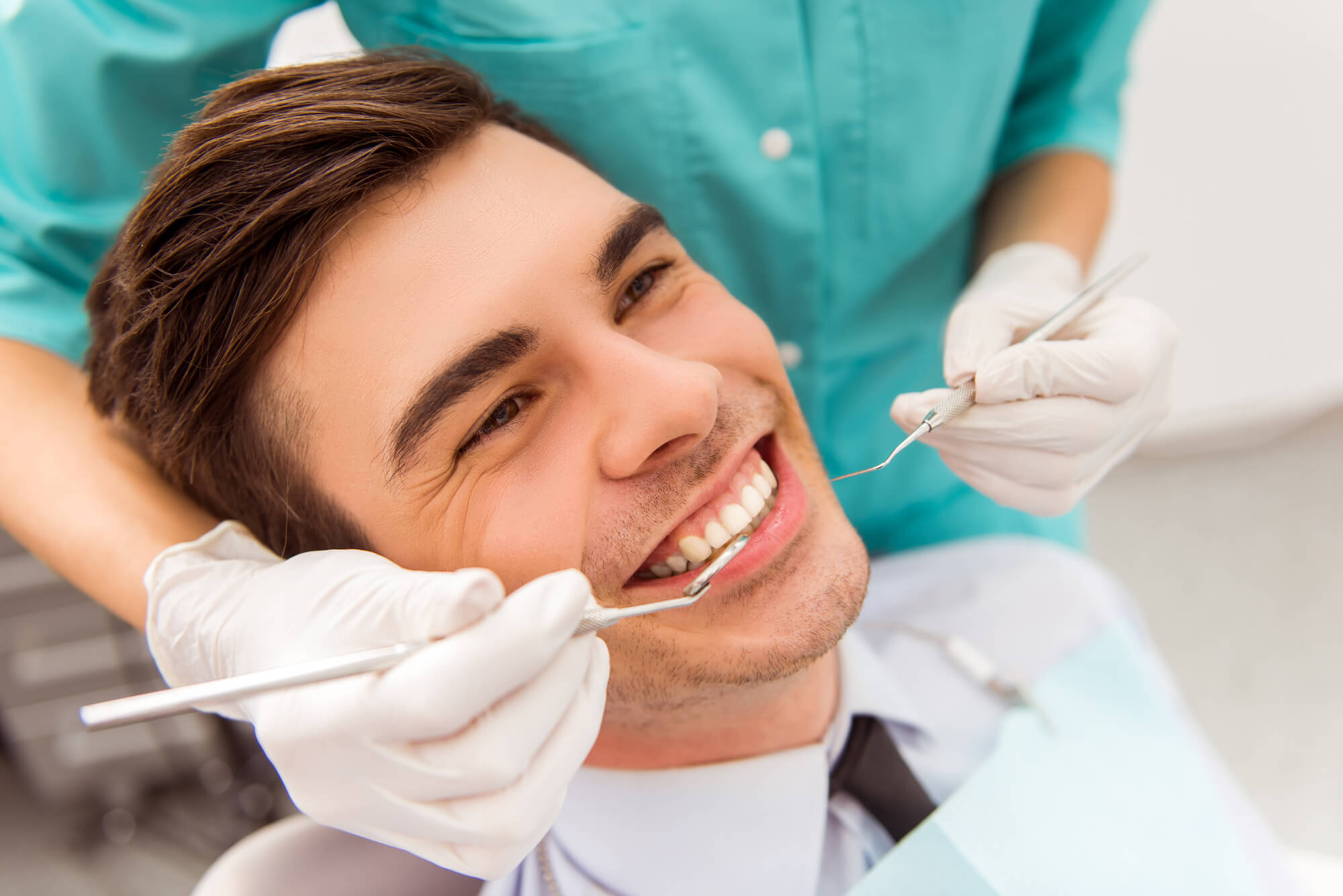 a male patient smiling at the Dentist in 33144